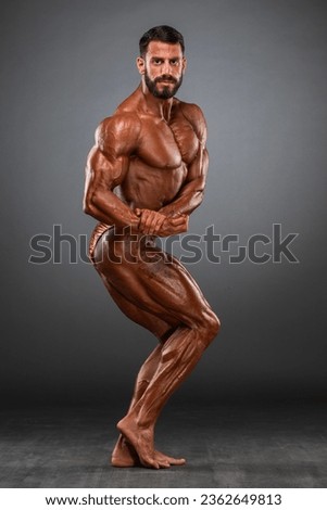 Body Builder Flexing Muscles. Studio Shot . Body Builder, Muscular Men posing