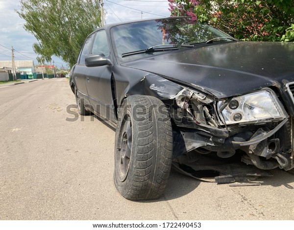 The body of the car is damaged\
as a result of an accident. High speed head on a car traffic\
accident. Dents on the car body after a collision on the\
highway