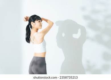 Body care concept of young woman. Sports gym. Stretching. - Powered by Shutterstock