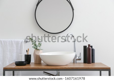 Body care cosmetics with accessories near sink in bathroom