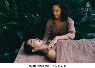 Body care and spa massage treatment for feeling harmony and bliss during beauty procedure at nature, Caucasian masseur have dayspa with relaxed Asian client doing rejuvenation and refresh therapy Foto Stock