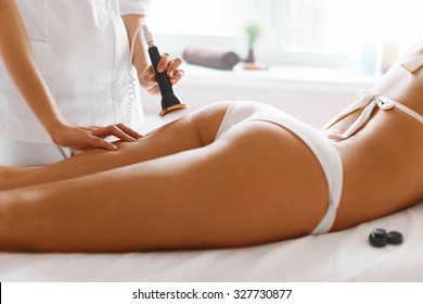 Body care. Spa treatment. Ultrasound cavitation body contouring treatment. Woman getting anti-cellulite and anti-fat therapy in beauty salon.