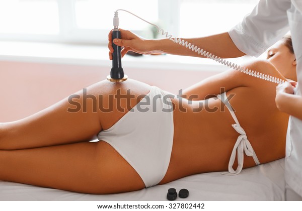 Body care. Ultrasound cavitation body\
contouring treatment. Woman getting anti-cellulite and anti-fat\
therapy on her tight buttocks in beauty salon. Spa treatment.\
Wellness, healthcare,\
lifestyle.
