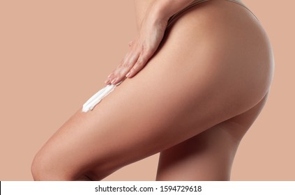 Body Care. Woman Applying Cream On Legs. Female Applying Anti Cellulite Cream