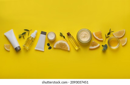 Body Cream And Other Cosmetic Products With Ingredients On Yellow Background, Flat Lay