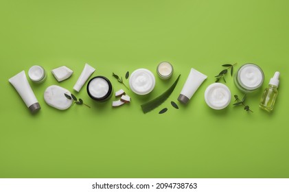 Body Cream And Other Cosmetic Products With Ingredients On Light Green Background, Flat Lay