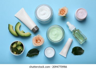 Body Cream And Other Cosmetic Products With Ingredients On Light Blue Background, Flat Lay
