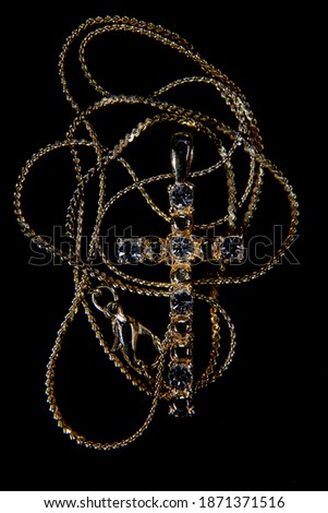 Body cross with jewerly and chain on black