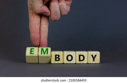 Body and embody symbol. Doctor turns wooden cubes and changes the concept word body to embody. Beautiful grey table, grey background, copy space. Medical, body and embody concept. - Shutterstock ID 2100184459