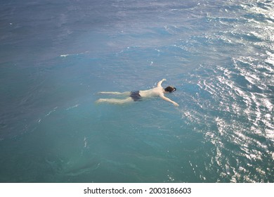 Body of a man floating in the ocean. The lifeless body of a man in the water. Drowned at sea in stormy weather.