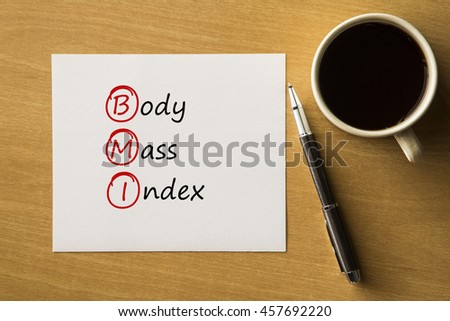 Body Mass Index (BMI) - handwriting on paper with cup of coffee and pen, acronym  concept