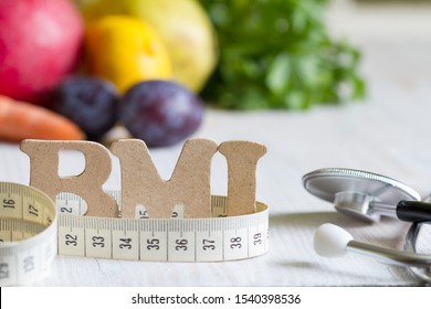 Body Mass Index BMI With Measuring Tape, Stethoscope And Fruits Concept