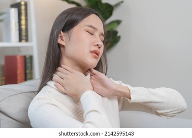 Body Muscles Stiff Problem, Asian Young Attractive Woman, Girl Pain With Neck Pain Ache From Work, Holding Massaging Rubbing Shoulder Hurt Or Sore, Painful Sitting On Sofa At Home. Healthcare People.
