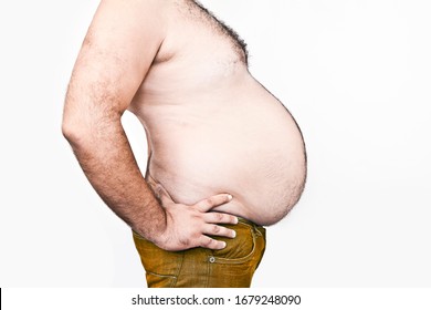 Body Part Of Asian Fat Man With A Big Hairy Belly. Overweight Man Closeup Of Belly Side View - Man Touching His Fat Belly - Fat Man & Diet, Belly Fat. Isolated On White Background. Unhealthy Lifestyle