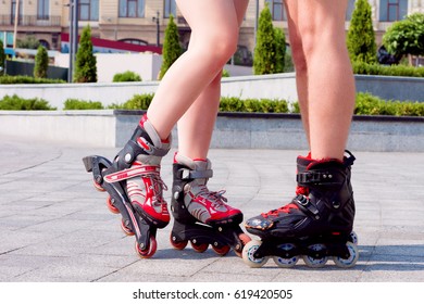 Body Parts. Close Up Of Couple's Legs Wearing Roller Skates. Couple In Love