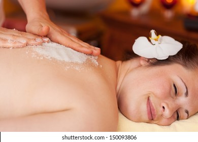 Body peel using coarse marine salt in a health centre or spa with the salt crystals used as an exfoliator and to replace essential minerals
