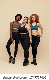 Body Positive. Diversity Women With Different Figure And Size Portrait. Group Of International Female In Sportswear Standing Against Beige Background. Sport As Lifestyle.