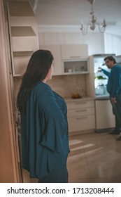 Body Positive Family Is Trying To Lead Healthy Lifestyle, Overweight Couple Are On Diet, Wife Caught Her Hungry Husband Taking Food In Refrigerator, Focus On Woman Standing In Foreground