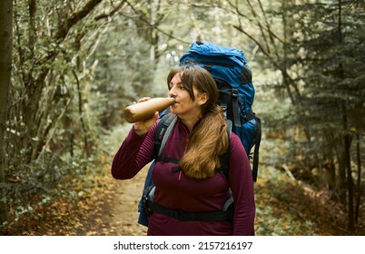 Body Positive Girl With A Backpack In Sportswear Drinks Water From A Bottle. The Concept Of Travel In The Mountains, Tourism.