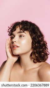 Body positive women and spa. Beautiful curly woman with shiny clean facial skin, white teeth, smiling and looking happy at camera, naked shoulders with glowing effect after beauty product. - Shutterstock ID 2206367889