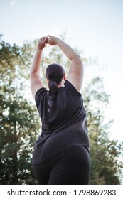 Body Positive, Yoga, Confidence, High Self Esteem, Meditating. Young Calm Overweight Woman Doing Yoga At Summer Nature. Obesity, Wellness, Outdoor Activity And Health.