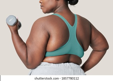 Body positivity curvy woman sportswear with dumbbell - Powered by Shutterstock