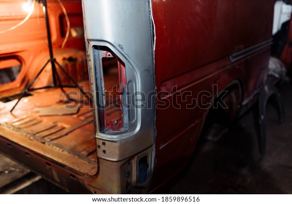 body\
repair of a red truck, welding of car body\
elements.