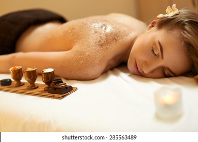 Body Scrub. Beautiful Blonde Gets A Salt Scrub Beauty Treatment In The Spa Salon