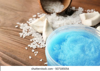 Body scrub, coconut and salt on wooden background