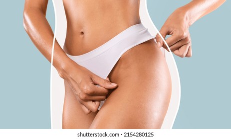 Body Shaping Spa And Slimming. Closeup cropped of unrecognizable fit lady wearing lingerie pulling up or down white panties standing isolated on blue studio background. Torso of slim female with lines