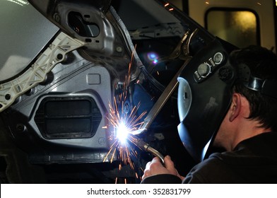 Body Shop Worker Welding Car Panel.