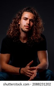 Body Shot Of An Attractive Male With Curly Long Hair Posing In Modern Style Clothing