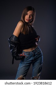 Body Shot Of A Stylish Woman Posing In Black Ripped Jeans And Sport Jacket