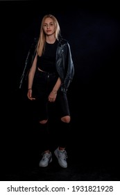 Body Shot Of A Stylish Woman Posing In Black Ripped Jeans And Sport Jacket