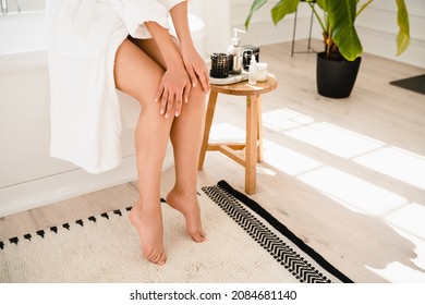 Body Skin Care Concept. Moisturizer After Hot Water Taking Bathroom Shower. Anti-cellulite Creme. Woman Applying Cream On Legs.