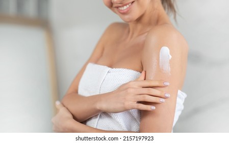 Body And Skin Care. Cropped Shot Of Lady Applying Cream On Shoulder Moisturizing Skin Standing Wrapped In Towel In Modern Bathroom At Home. Beauty And Bodycare Cosmetics. Selective Focus - Powered by Shutterstock