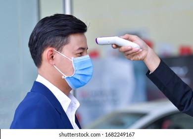 Body temperature check, prevent virus Concepts in preventing contagious diseases. Corona virus [Covid-19] Wash your hands with an alcohol gel to kill bacteria. Medical infrared thermometer use body. - Shutterstock ID 1682249167