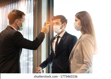 Body temperature check, prevent virus Concepts in preventing contagious diseases. Corona virus [Covid-19] . social distancing concept.Operator Check Fever by Digital Thermometer Visitor - Powered by Shutterstock