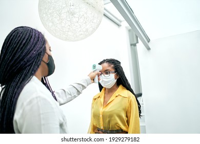 Body temperature check, prevent virus Concepts in preventing contagious diseases. Social distancing concept. Operator Check Fever by Digital Thermometer Visitor - Powered by Shutterstock