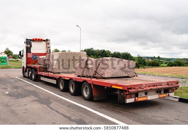 Body of the truck loaded\
with marble slabs in a stone cutting factory. transport of huge\
stone slabs