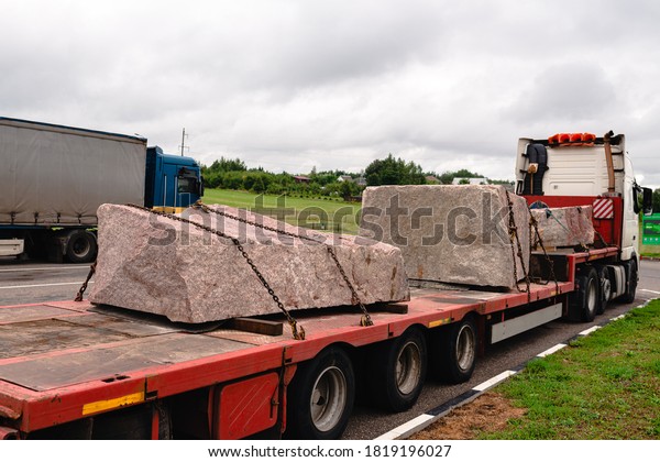 Body of the truck loaded\
with marble slabs in a stone cutting factory. transport of huge\
stone slabs