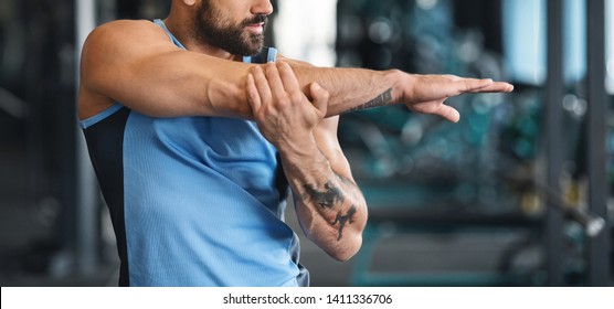 Body Warmup. Man Stretching Arms Before Workout At Gym, Panorama With Free Space