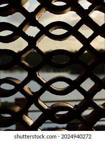 a body of water framed by a brick pattern at sunrise