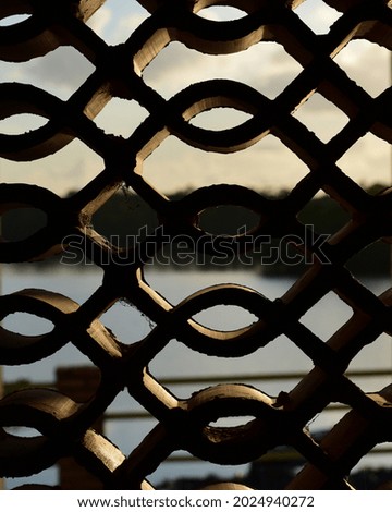 a body of water framed by a brick pattern at sunrise