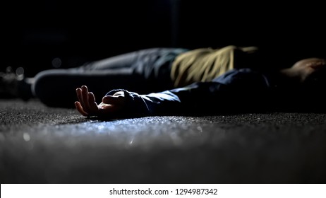 Body of woman lying on ground, contract killing, revenge or robbery, horror - Shutterstock ID 1294987342