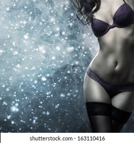 Body Of Young And Beautiful Woman In Sexy Lingerie Over The Snowy Winter Background