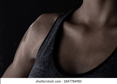 Body Of Young Fitness Woman Who Has Hot Sweat From Exercise, Sweaty On Neck Chest Chin Part. Low Exposure Dark Background Copy Space