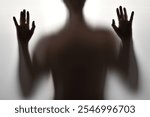 Body of a young man, Creepy shadow of a figure behind a curtain. The concept of emotive experiences and fear. Emotional state of depression. Halloween image.