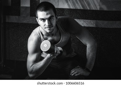 bodybuilder athletic guy execute biceps exercise with dumbbellsfitness,