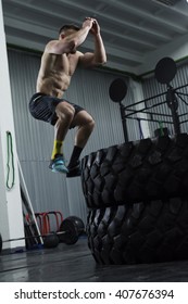 Bodybuilder doing box jumps at the gym